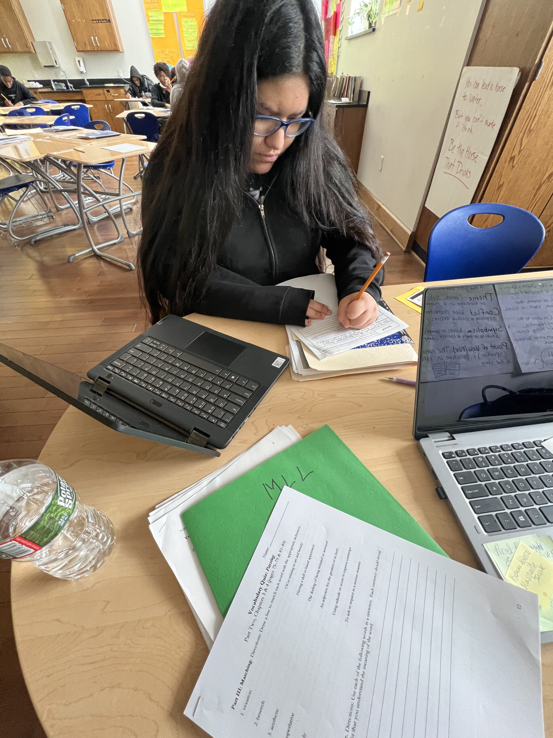 Single student completing a worksheet at a desk.